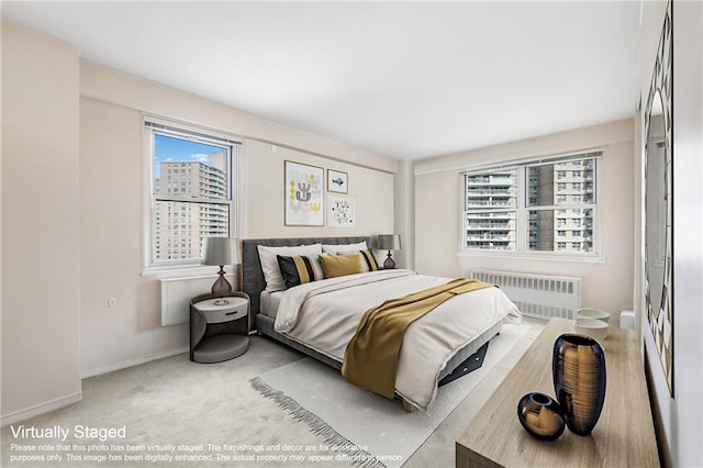 carpeted bedroom featuring radiator heating unit and baseboards