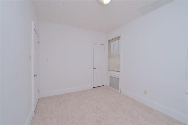 carpeted spare room featuring baseboards