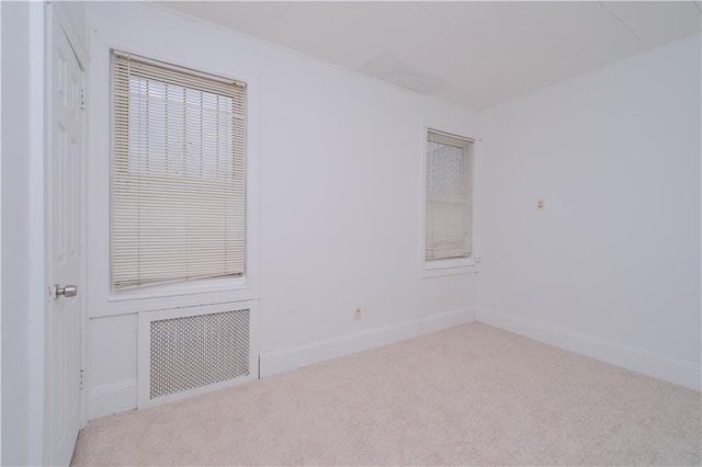 unfurnished room featuring carpet floors and baseboards