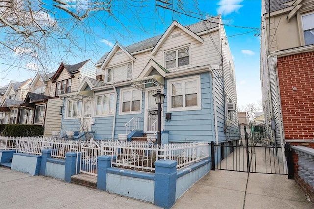 view of front of home with a gate, a fenced front yard, and a residential view