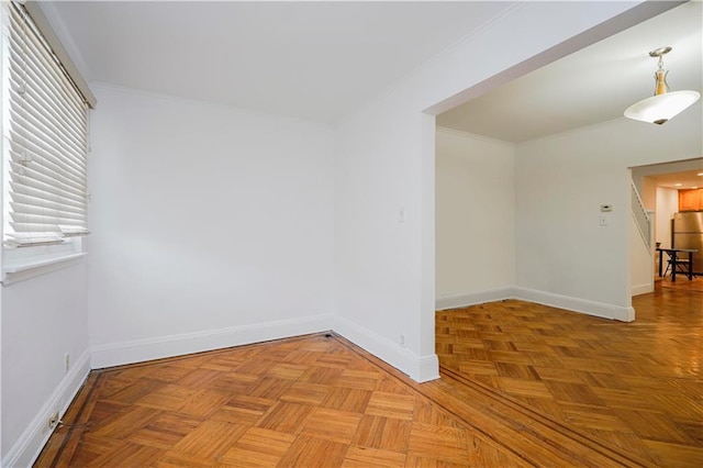 unfurnished room with ornamental molding and baseboards