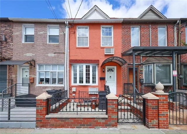 2961 Voorhies Ave, Brooklyn, NY 11235 - multi unit property featuring brick siding, a fenced front yard, and a wall unit AC