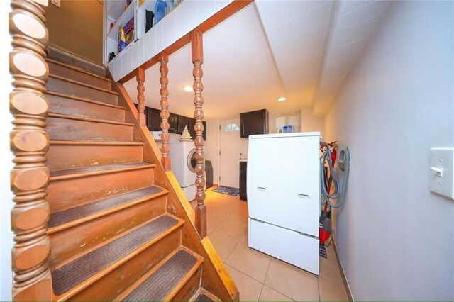 2961 Voorhies Ave, Brooklyn, NY 11235 - stairs with tile patterned flooring, washing machine and clothes dryer, and recessed lighting