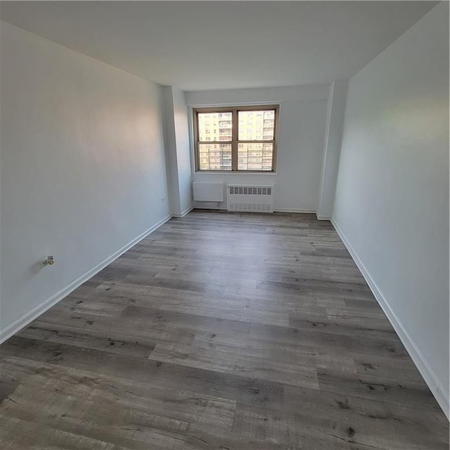 1065 Vermont St Unit 6D, Brooklyn, NY 11207 - spare room with radiator, wood finished floors, and baseboards