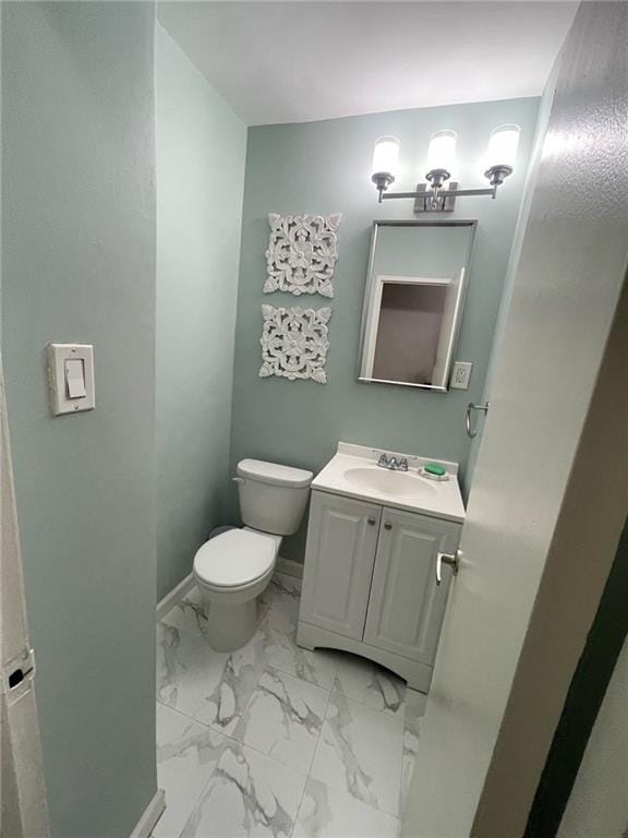 1065 Vermont St Unit 6D, Brooklyn, NY 11207 - half bath featuring toilet, vanity, marble finish floors, and baseboards