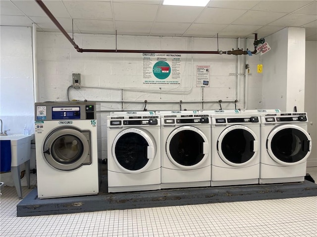 1065 Vermont St Unit 6D, Brooklyn, NY 11207 - shared laundry room featuring washing machine and dryer, concrete block wall, and tile patterned flooring