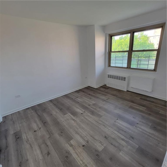 1065 Vermont St Unit 6D, Brooklyn, NY 11207 - spare room with radiator, wood finished floors, and baseboards