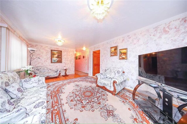 2235A 84th St Unit 1C, Brooklyn, NY 11214 - living room with wallpapered walls, ornamental molding, and wood finished floors