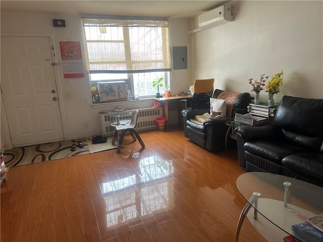 2878 W 16th St, Brooklyn, NY 11224 - living area featuring radiator heating unit, a wall mounted AC, electric panel, and wood finished floors