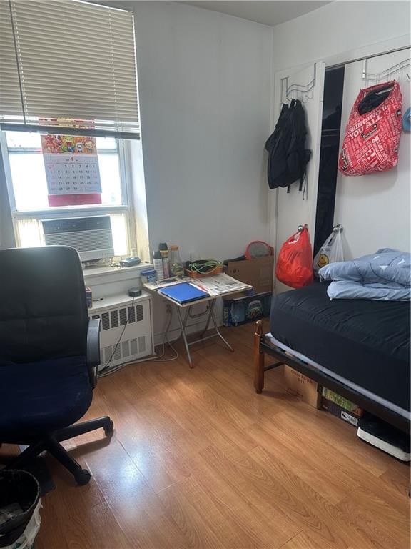 2878 W 16th St, Brooklyn, NY 11224 - bedroom featuring radiator, wood finished floors, and a desk