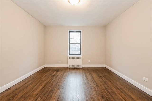 1119 Ocean Pkwy Unit 2A, Brooklyn, NY 11230 - empty room featuring radiator, dark wood-style flooring, and baseboards