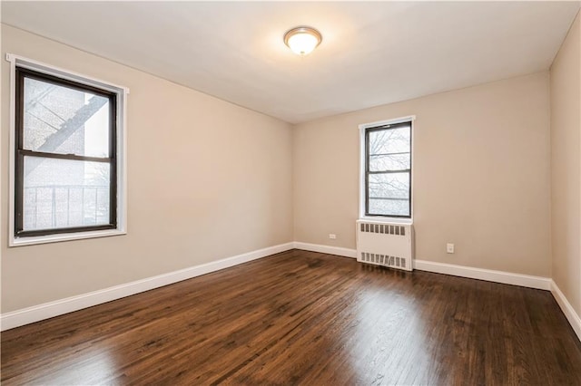 1119 Ocean Pkwy Unit 2A, Brooklyn, NY 11230 - unfurnished room with radiator heating unit, baseboards, and dark wood-style flooring