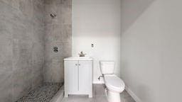 7902 16th Ave, Brooklyn, NY 11214 - full bathroom featuring a shower stall, toilet, and vanity