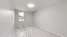 7902 16th Ave, Brooklyn, NY 11214 - empty room featuring baseboards and wood finished floors