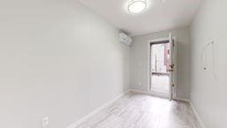 7902 16th Ave, Brooklyn, NY 11214 - empty room with baseboards and light wood-style floors