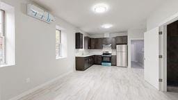 7902 16th Ave, Brooklyn, NY 11214 - kitchen with freestanding refrigerator, light countertops, dark brown cabinetry, light wood-style floors, and baseboards