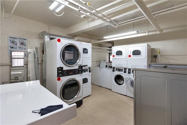 community laundry with stacked washer / drying machine and washer and clothes dryer