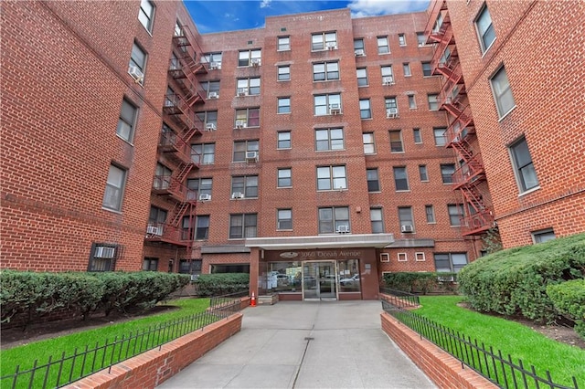 view of apartment building / complex featuring fence