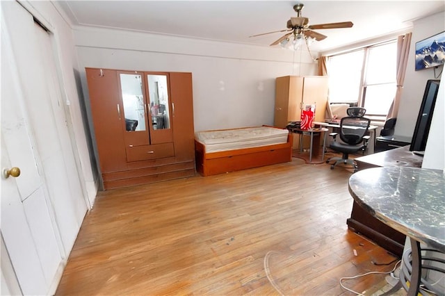 home office with wood finished floors and a ceiling fan