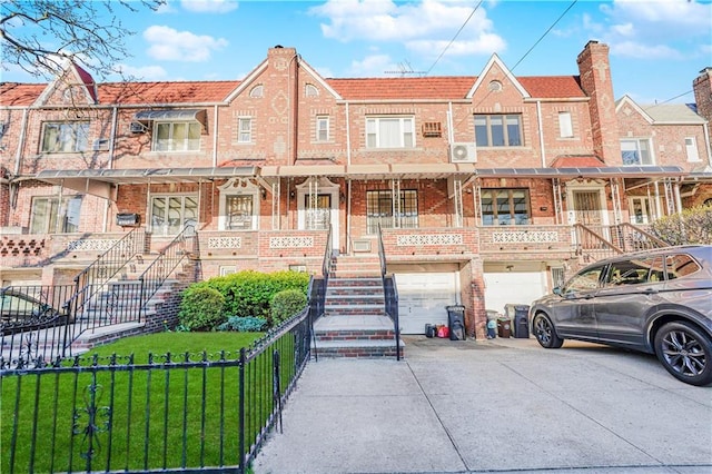 4715 Bedford Ave, Brooklyn, NY 11235 - view of front of home with driveway, stairs, an attached garage, and brick siding