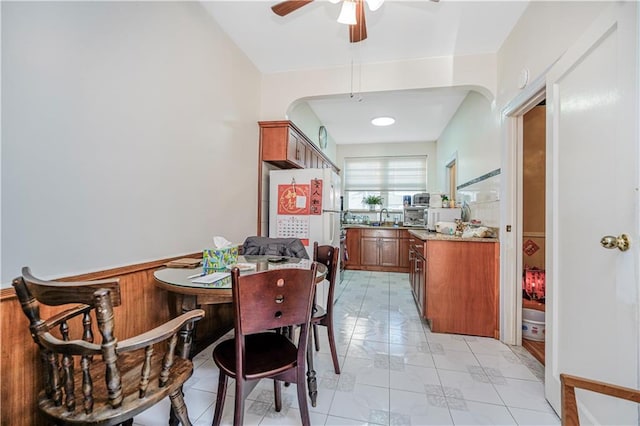 4715 Bedford Ave, Brooklyn, NY 11235 - dining room with a ceiling fan, arched walkways, and light tile patterned flooring