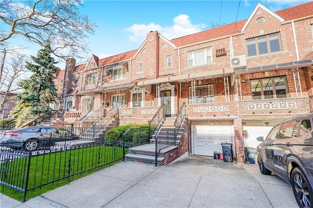4715 Bedford Ave, Brooklyn, NY 11235 - view of front of house with driveway, brick siding, a garage, and stairs