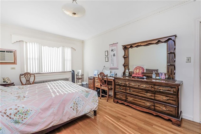 4715 Bedford Ave, Brooklyn, NY 11235 - bedroom with light wood-type flooring, crown molding, radiator, and a desk