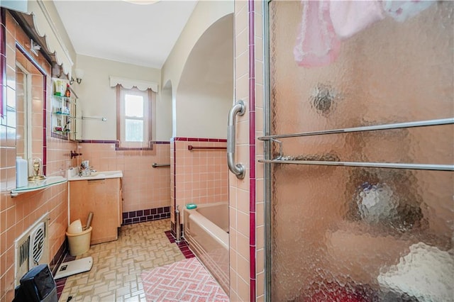 4715 Bedford Ave, Brooklyn, NY 11235 - bathroom with tile walls, a wainscoted wall, and vanity