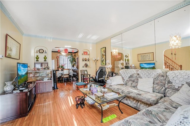4715 Bedford Ave, Brooklyn, NY 11235 - living room with arched walkways, light wood finished floors, crown molding, a chandelier, and stairway