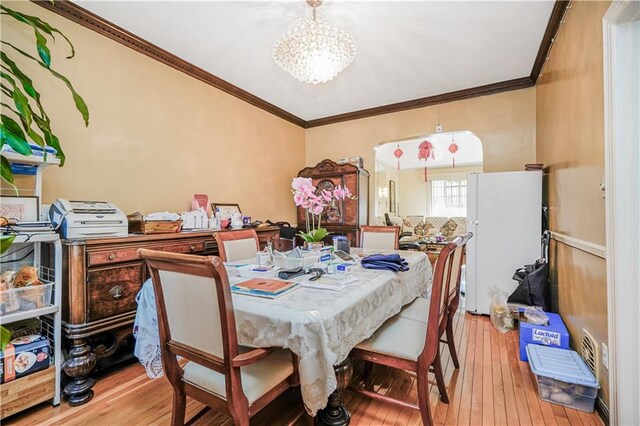 4715 Bedford Ave, Brooklyn, NY 11235 - dining space featuring hardwood / wood-style floors, a chandelier, and crown molding