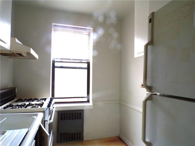 kitchen with visible vents and white appliances
