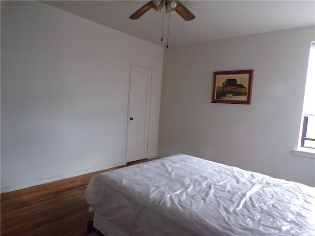 bedroom with wood finished floors, ceiling fan, and baseboards