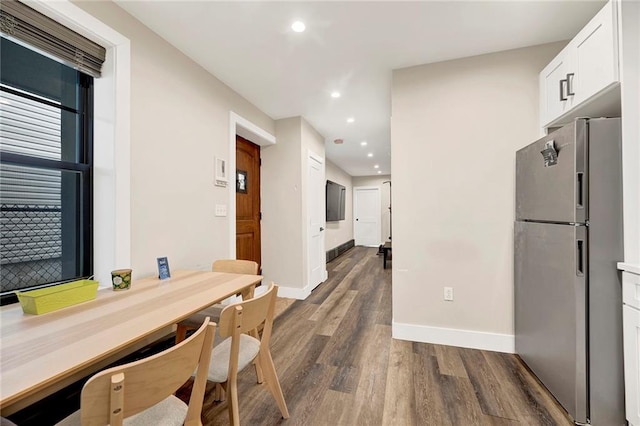dining space with baseboards, recessed lighting, and dark wood-style floors