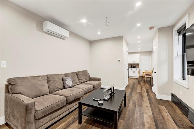 living room featuring recessed lighting, baseboards, an AC wall unit, and dark wood finished floors