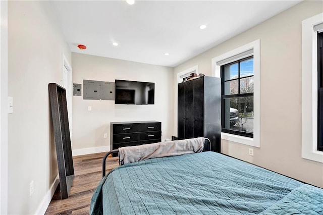 bedroom with recessed lighting, baseboards, and wood finished floors