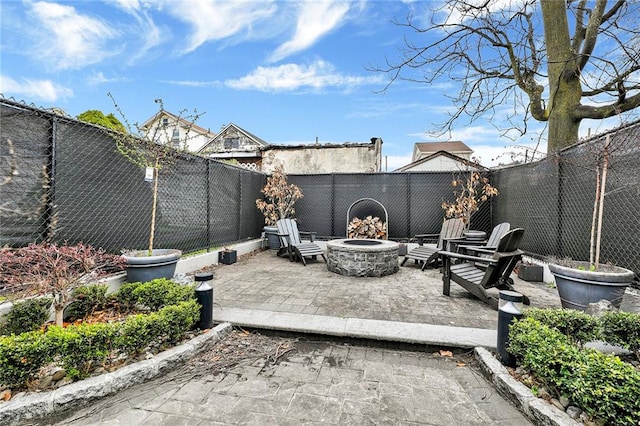 view of patio with a fenced backyard and an outdoor fire pit
