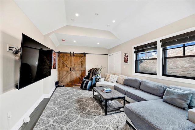 living room featuring a barn door, wood finished floors, baseboards, lofted ceiling, and recessed lighting