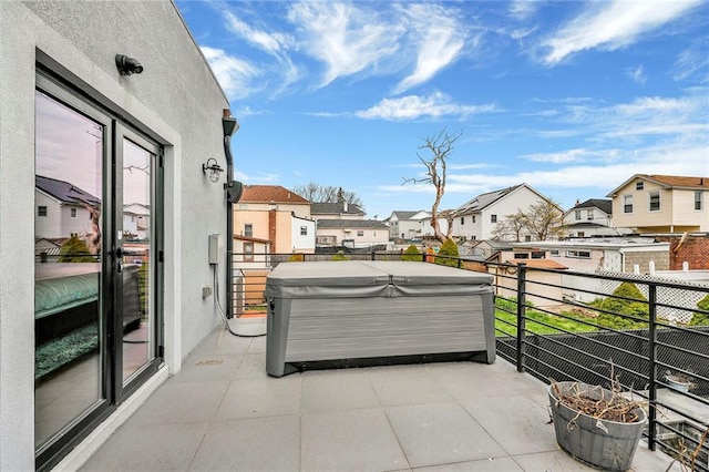 balcony featuring a residential view and a hot tub