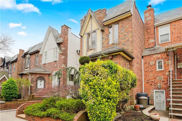 view of home's exterior with brick siding and a high end roof