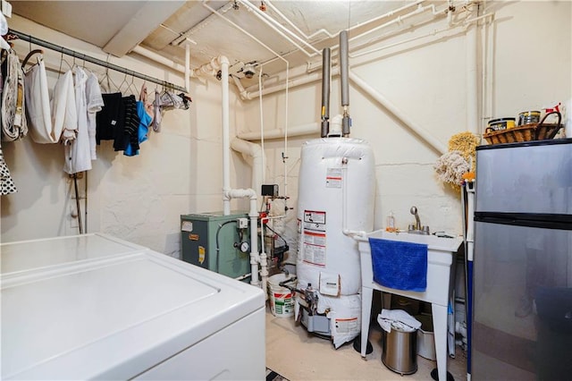 unfinished below grade area with washer and clothes dryer, freestanding refrigerator, water heater, and a heating unit
