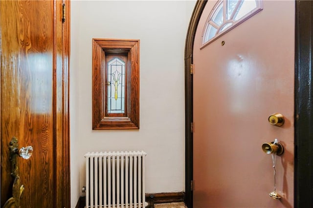corridor featuring radiator and plenty of natural light