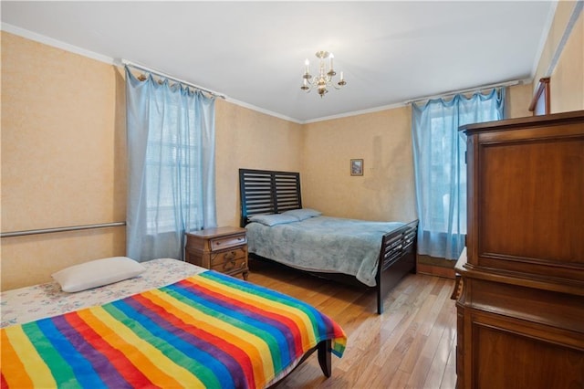 bedroom with light wood-style floors, multiple windows, ornamental molding, and an inviting chandelier