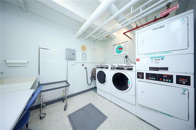 common laundry area featuring electric panel, independent washer and dryer, and stacked washer / dryer