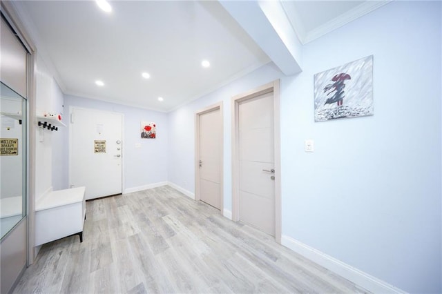 corridor featuring crown molding, recessed lighting, light wood-style floors, and baseboards