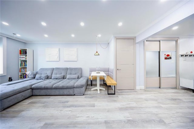 living room with recessed lighting, ornamental molding, and wood finished floors