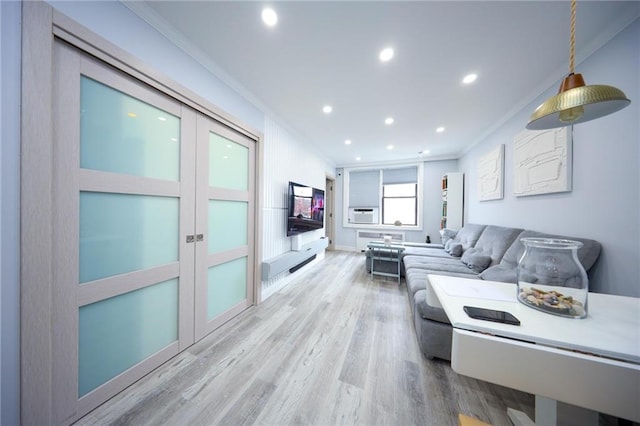 living room featuring recessed lighting, ornamental molding, and wood finished floors