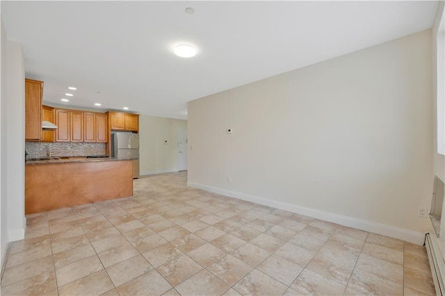 2138 Bath Ave Unit 1A, Brooklyn, NY 11214 - kitchen featuring freestanding refrigerator, recessed lighting, backsplash, a peninsula, and under cabinet range hood