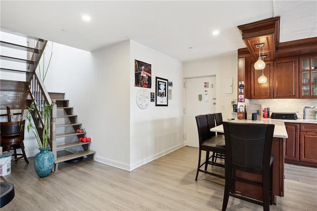 2752 Ocean Ave Unit 6A, Brooklyn, NY 11229 - kitchen featuring a breakfast bar area, light countertops, decorative backsplash, light wood-type flooring, and recessed lighting