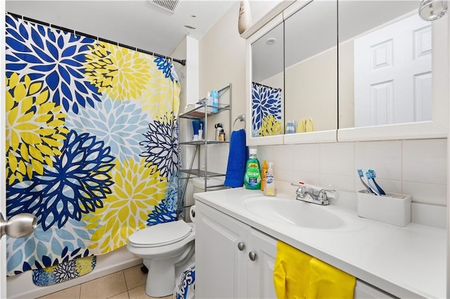 bathroom featuring toilet, vanity, tile patterned floors, and curtained shower