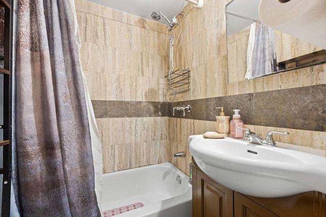 full bathroom with tile walls, vanity, and shower / bath combo